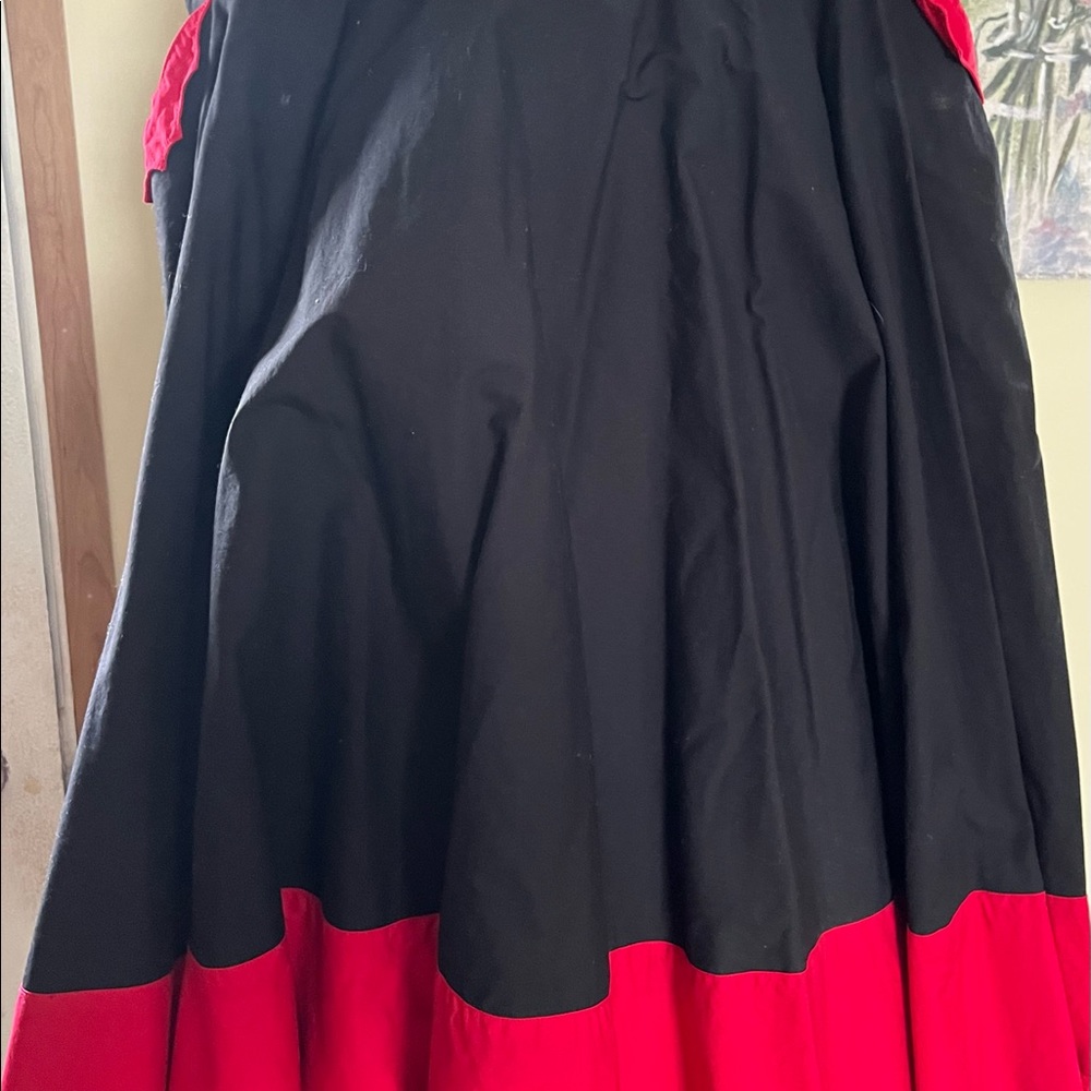 Black circle skirt with red bats at pocket